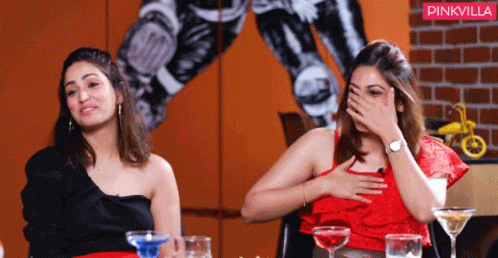 Two Women Are Sitting At A Table With A Pinkvilla Logo In The Background GIF