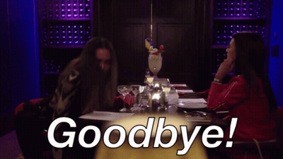 Two Women Are Sitting At A Table With The Words Goodbye Written On It GIF