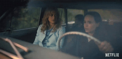 Two Women Are Sitting In A Car With Netflix Written On The Bottom GIF
