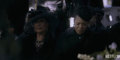 Two Women Are Sitting In A Crowd With A Netflix Logo Behind Them GIF