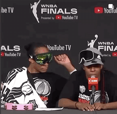 Two Women Are Sitting In Front Of A Youtube Tv Banner GIF