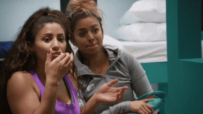 Two Women Are Sitting Next To Each Other And One Is Wearing A Nike Sweatshirt GIF