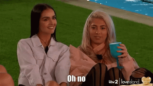 Two Women Are Sitting Next To Each Other And One Of Them Is Holding A Wine Glass And The Other Is Saying " Oh No " GIF
