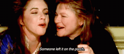 Two Women Are Sitting Next To Each Other And One Of Them Is Saying Someone Left It On The Porch GIF
