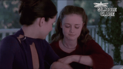 Two Women Are Sitting Next To Each Other And The Words Gilmore Clube Are On The Bottom GIF