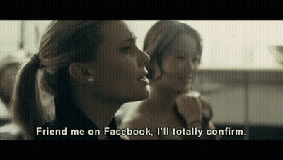 Two Women Are Sitting Next To Each Other In A Kitchen And One Of Them Is Talking About Facebook . GIF