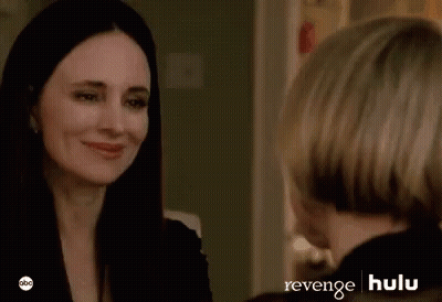 Two Women Are Sitting Next To Each Other In A Room And Looking At Each Other . GIF