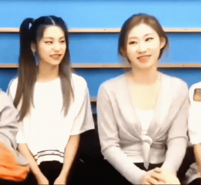 Two Women Are Sitting Next To Each Other In A Room And Smiling . GIF