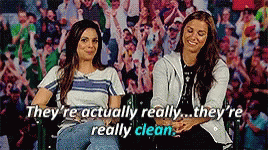 Two Women Are Sitting Next To Each Other In Front Of A Crowd And They Are Actually Really Clean GIF