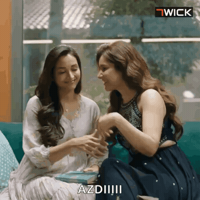 Two Women Are Sitting Next To Each Other On A Couch And One Of Them Is Saying Azdii GIF
