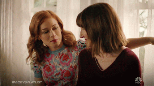 Two Women Are Sitting Next To Each Other With The Hashtag #Zoeysplaylist On The Bottom GIF