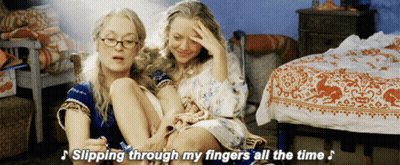 Two Women Are Sitting Next To Each Other With The Words " Slipping Through My Fingers All The Time " Above Them GIF