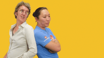 Two Women Are Standing Back To Back With The Words " You Got My Back " Behind Them GIF