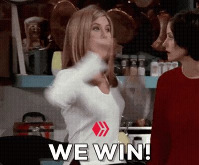 Two Women Are Standing In A Kitchen With The Words We Win Written On Their Shirts GIF