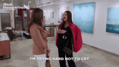 Two Women Are Standing In A Room With The Words I 'M Trying Hard Not To Cry GIF