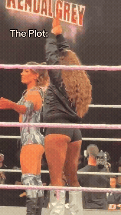 Two Women Are Standing In A Wrestling Ring With A Sign That Says Kendal Grey GIF