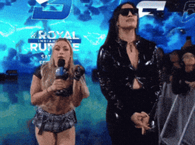 Two Women Are Standing In Front Of A Sign That Says Royal GIF