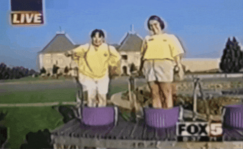 Two Women Are Standing In Purple Baskets With The Fox 5 Logo In The Background GIF