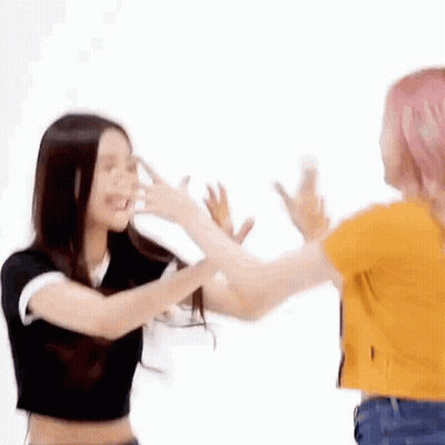 Two Women Are Standing Next To Each Other And Having A Fight . GIF
