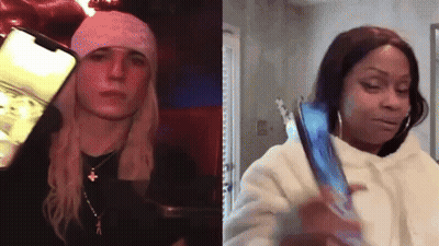 Two Women Are Standing Next To Each Other And One Is Holding A Cell Phone . GIF