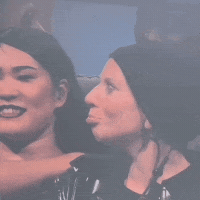 Two Women Are Standing Next To Each Other And One Is Making A Face . GIF