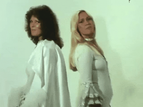 Two Women Are Standing Next To Each Other And One Is Singing . GIF
