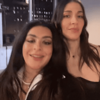 Two Women Are Standing Next To Each Other And Smiling . GIF
