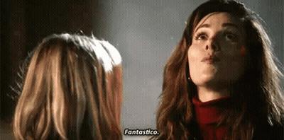 Two Women Are Standing Next To Each Other And Talking To Each Other . GIF