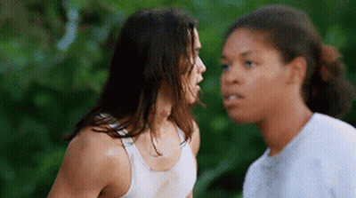 Two Women Are Standing Next To Each Other And Talking To Each Other GIF