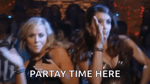 Two Women Are Standing Next To Each Other In A Club . GIF
