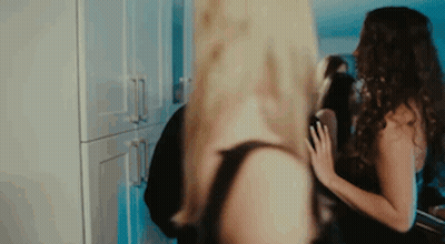Two Women Are Standing Next To Each Other In A Kitchen In Lingerie . GIF