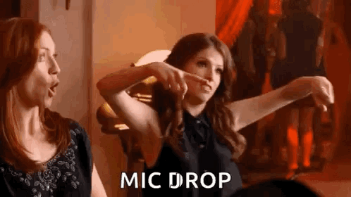 Two Women Are Standing Next To Each Other In A Room . GIF