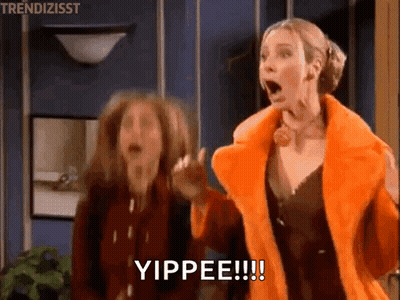 Two Women Are Standing Next To Each Other In A Room With Their Mouths Open And One Of Them Is Wearing An Orange Fur Coat GIF