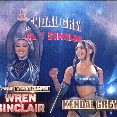 Two Women Are Standing Next To Each Other In Front Of A Banner That Says Kendal Grey GIF