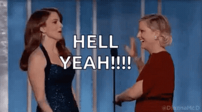 Two Women Are Standing Next To Each Other In Front Of A Microphone And Talking . GIF