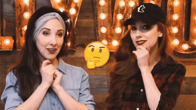 Two Women Are Standing Next To Each Other In Front Of A Sign That Says Tumblr GIF
