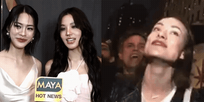 Two Women Are Standing Next To Each Other With A Sign That Says Maya Hot News . GIF