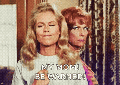 Two Women Are Standing Next To Each Other With One Saying My Mom Be Warned GIF