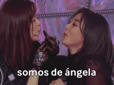 Two Women Are Standing Next To Each Other With Their Hands In The Air And The Words Somos De Angela On The Bottom . GIF