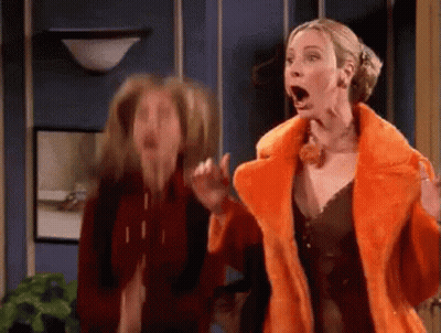 Two Women Are Standing Next To Each Other With Their Mouths Open . One Of The Women Is Wearing A Fur Coat . GIF