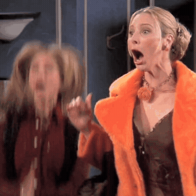Two Women Are Standing Next To Each Other With Their Mouths Open . One Of The Women Is Wearing A Fur Coat . GIF
