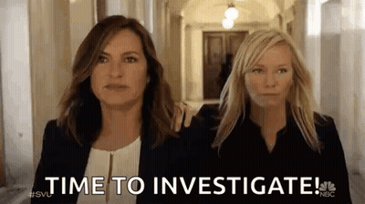 Two Women Are Walking Down A Hallway And One Of Them Is Holding The Other 'S Arm . GIF