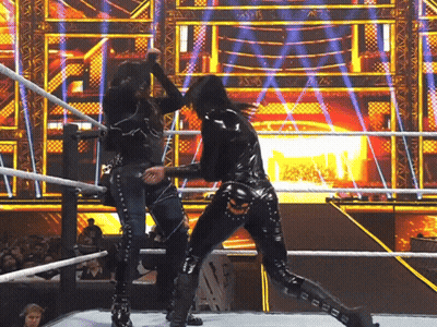 two women are wrestling in a ring and one of them is wearing a black latex outfit