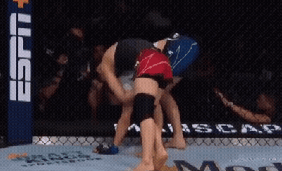 Two Women Are Wrestling In A Ring With A Espn Banner In The Back GIF
