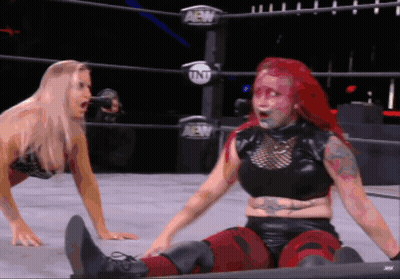 Two Women Are Wrestling In A Ring With Aew Written On The Side GIF