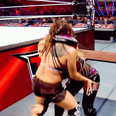 Two Women Are Wrestling In A Ring With The Words Tlc Tables On The Bottom Right GIF