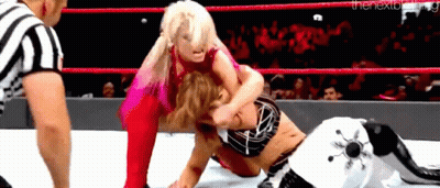 Two Women Are Wrestling In A Wrestling Ring With A Referee Watching . GIF