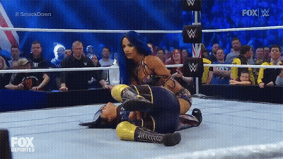 Two Women Are Wrestling In A Wrestling Ring With Fox Deportes On The Screen GIF
