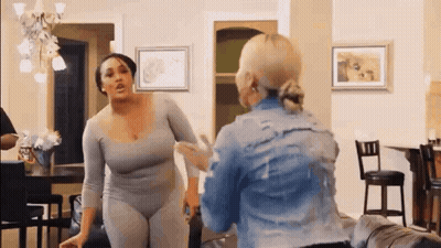 Two Women Arguing In Living Room GIF