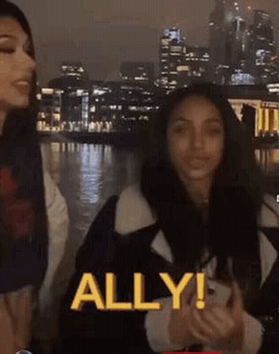 Two Women At Night City One Holding Phone GIF